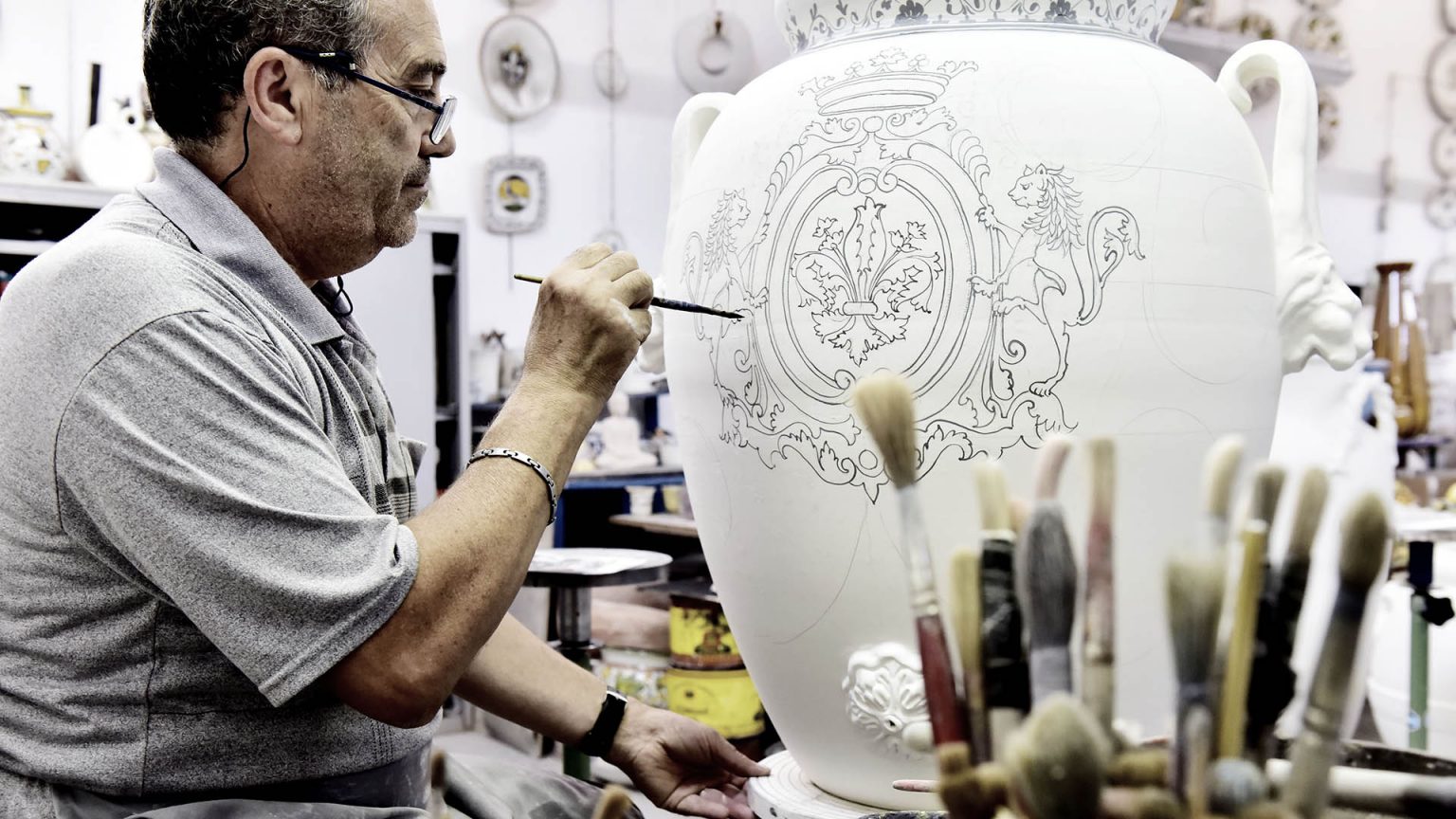 tuscan artisan sketching onto a pot